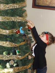 Sawyer decorating the tree in the sitting room...